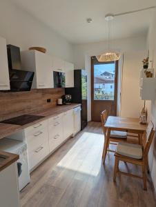 a kitchen with a table and a dining room at City Center Rooms in Mayrhofen