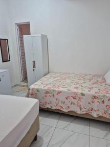 a bedroom with two beds and a white cabinet at Manancial de Aguas V in Barreirinhas
