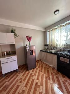a kitchen with a stainless steel refrigerator in a room at Wiracocha Apartments #1 in Cusco