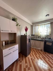 a kitchen with a black refrigerator and a counter at Wiracocha Apartments #1 in Cusco +10 photos