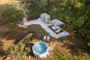 an aerial view of a house and a boat in a field at Olívia, Caravana Vintage, Castelo de Vide in Castelo de Vide