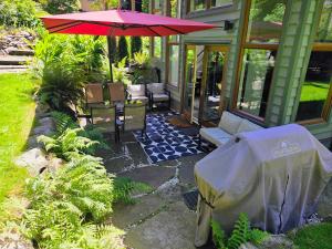 a patio with a table and an umbrella at 2BD Guest Suite Sleeps 6 Near Downtown & Beach in West Vancouver
