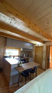 a kitchen with a table and chairs in a cabin at Camp Birch Forest in Pljevlja
