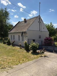 a white house with a fence in front of it at Moja Vojvodjanka in Gornja Rogatica