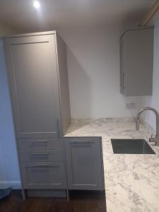 a kitchen with a sink and a counter at Clubhouse 3 in Bedale +23 photos