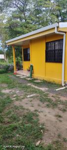 a yellow house with a green fire hydrant in front of it at Casa Amarilla in San Blas