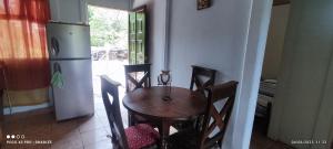 a kitchen with a table and chairs and a refrigerator at Casa Amarilla in San Blas