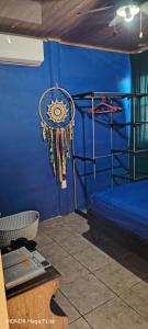 a room with a blue wall with a bunk bed at Casa Amarilla in San Blas