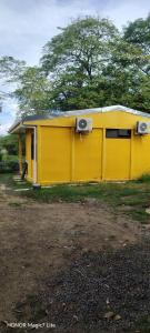 a yellow building with speakers on the side of it at Casa Amarilla in San Blas