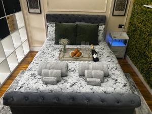 a large bed with a tray of food on it at Stylish 1-Bed Apartment in Chester with Parking & Full Kitchen in Chester