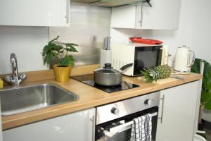 a kitchen with a sink and a stove and a counter top at Stylish Studio in the Heart of Sheffield in Sheffield +10 photos