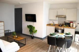 a kitchen with a table in a living room at Stylish Studio in the Heart of Sheffield in Sheffield
