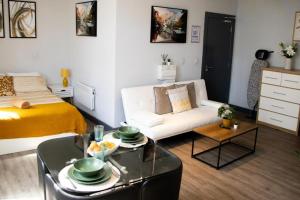 a small living room with a bed and a couch at Stylish Studio in the Heart of Sheffield in Sheffield