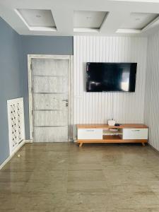 a living room with a television on the wall at Lengliz in Kelibia