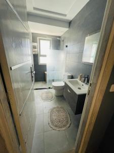 a bathroom with a toilet and a sink at Lengliz in Kelibia