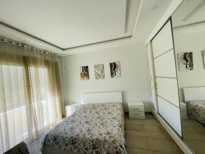 a bedroom with a bed and a mirror at Lengliz in Kelibia