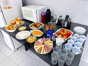 a counter with many bowls of food and other foods at Hotel São Miguel in Posse