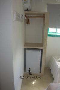 a room with a shelf in the corner of a room at Pousada Vila das Águas in Caraíva