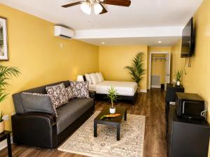a living room with a couch and a bed at Torraille Waterfall Villas in Soufrière
