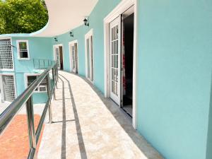 a corridor of a house with a blue wall at Torraille Waterfall Villas in Soufrière