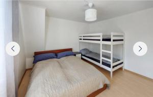 a bedroom with a bed and a bunk bed at Grå villa in Vislanda