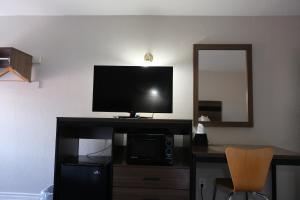 a flat screen tv sitting on top of a desk at La Villita Inn in San Antonio