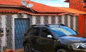 a black suv parked in front of a house at Nosso Cantinho no interior in Lençóis