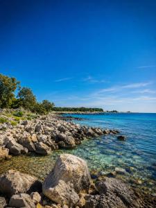 a group of rocks on the shore of a body of water at Apartmani Morѐll 1 in Novalja
