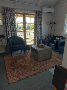 a living room with a couch and a coffee table at The Cosy Nook in Waimate +2 photos