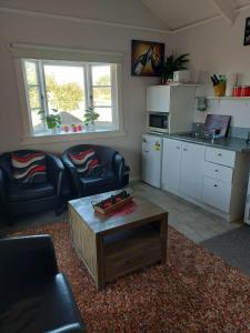 a living room with a couch and a coffee table at The Cosy Nook in Waimate