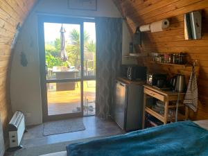 a bedroom with a door leading to a patio at The Dome Waikino in Waikino