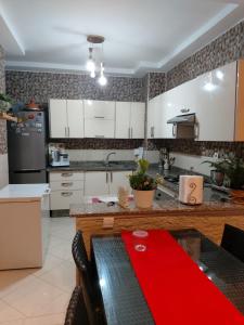 a kitchen with a table with a red napkin on it at Bouznika DREAMS in Bouznika