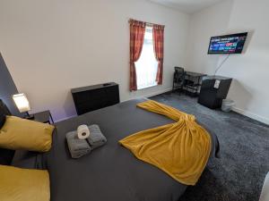 a bedroom with a bed with a yellow blanket on it at Stay Sleep Rest - Cranbrook in Doncaster