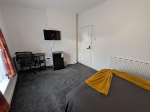 a bedroom with a bed and a television and a chair at Stay Sleep Rest - Cranbrook in Doncaster +24 photos