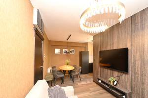 a living room with a television and a table at Casa Nuova in Kotor