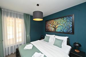 a bedroom with a large bed with a painting on the wall at Casa Nuova in Kotor