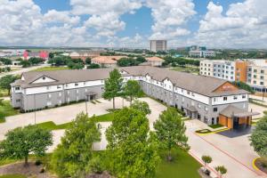an aerial view of a campus with buildings at Hawthorn Extended Stay by Wyndham DFW Airport North in Irving