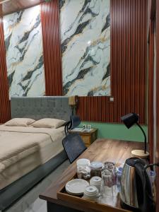 a hotel room with a bed and a table with dishes on it at Nanda Harum Villa in Sangyang