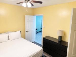 a bedroom with a bed and a ceiling fan at Torraille Waterfall Villas Main Suites in Soufrière