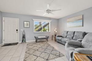 a living room with a couch and a ceiling fan at Shark tooth Condo in Venice