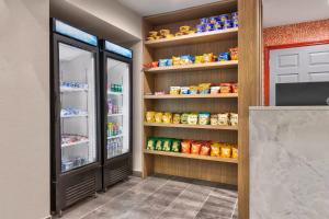 a kitchen with an open refrigerator with food inside at Hawthorn Extended Stay by Wyndham DFW Airport North in Irving