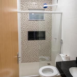 a bathroom with a shower with a toilet and a sink at Anápolis city in Anápolis +3 photos