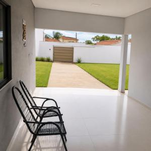 a chair sitting on the porch of a house at Anápolis city in Anápolis