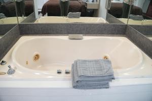 a white bath tub with a towel in it at Relax Inn in Webster +40 photos