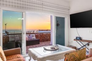a living room with a view of the ocean at Dog-Friendly Ocean-view Villa with Patio, Outdoor Pool, Streaming, partial AC in Rosarito