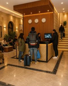 a man standing at a counter in a lobby at Lava pyramids hotel in Cairo