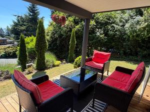 a patio with two chairs and a table with at Cozy Ocean View Retreat in Victoria
