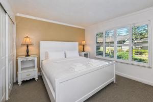 a bedroom with a white bed and a window at Spacious 2BR condo with pool, fireplace,at Silverado Country Club in Napa +16 photos