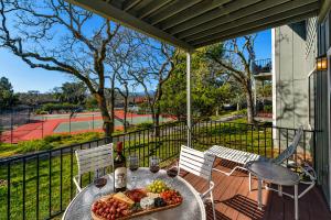 a table with a tray of fruit and wine glasses at Spacious 2BR condo with pool, fireplace,at Silverado Country Club in Napa