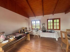 a room with a table in a room withwindows at Hotel Turi Atacama in San Pedro de Atacama